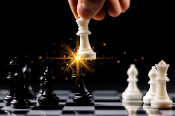 Businessman hand holding and moving white king chess figure with competitor to success play....