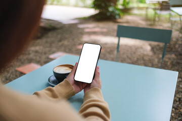 Mockup image of a woman holding mobile phone with blank screen in the outdoors