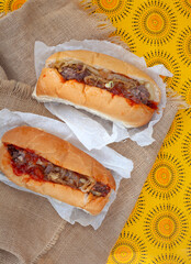 Traditional South African Boerewors rolls on burlap and printed fabric