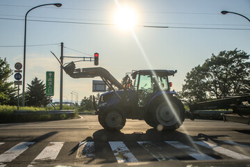 Urban Intersection with Tractor Silhouette in Sunlight