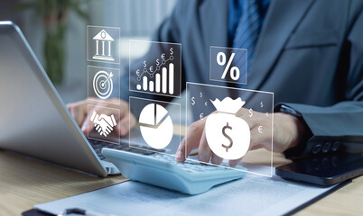 Businessman using laptop with virtual financial icons including money bag. Concept of investment,...