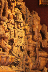 Hand-carved wooden statues of Hindu gods Ganesha, Balaji, traditional Indian craftsmanship, spiritual decor, religious art, close-up