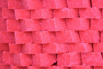 Pink Indian sweet dessert cubes arranged neatly as textured background, traditional mithai food for Diwali, Holi, wedding, food photography, abstract pink pattern.