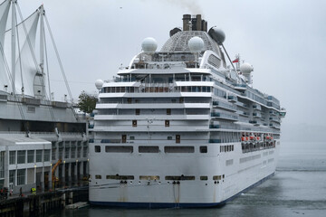 Modern Princess cruiseship cruise ship liner Coral arrival into Vancouver, Canada port on grey...