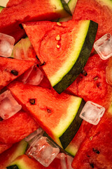 Close-up of fresh watermelon slices with ice cubes, top view summer food background