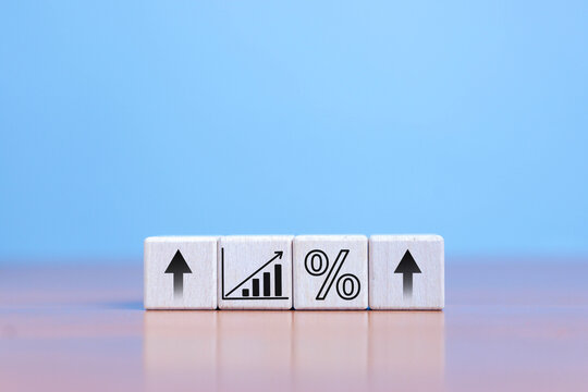 Concept of rising wooden blocks with percentage symbol, up direction icon, high inflation concept, financial interest rates and mortgage rates, rising selling prices and taxes.