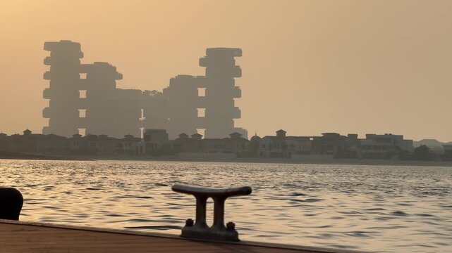 Atlantis The Royal stands out against the sunset colours and the pier extends towards the waters of Palfrey Jumeirah in Dubai.