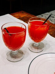 Refreshing drinks served in elegant glasses on a table in a cozy dining area during evening hours