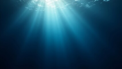 Sunlight streams down through the deep blue ocean water