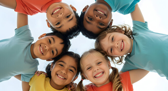 Happy diverse children huddle together, showcasing unity, friendship, and teamwork in a bright and cheerful outdoor setting.
