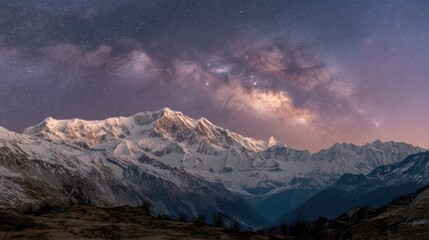 Fototapeta premium Snowy mountain range under a starry night sky.