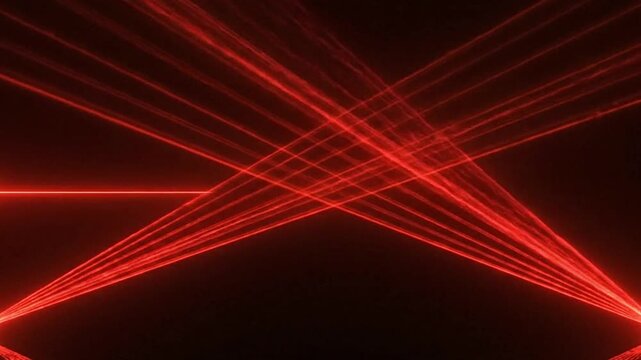 Red laser beams crisscross in a dark space creating intersecting patterns