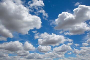 Obraz premium Puffy white clouds floating in a bright blue sky