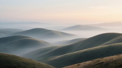 Rolling green hills stretch into the misty horizon at sunrise, creating a serene and peaceful landscape with soft light and gentle curves.