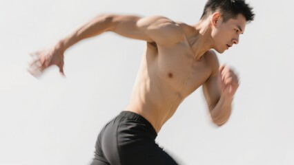 A shirtless man in black shorts is sprinting, showcasing his muscular build and intense focus against a plain background.