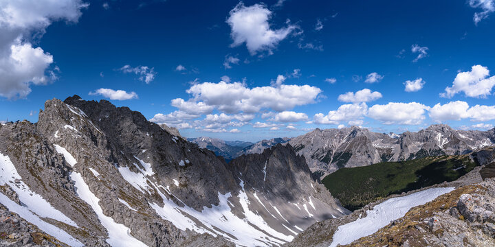 Stunning panorama view of Seegrubenspitze peak and Tyrolean Alps massif from top of Hafelekarspitze peak in spring on a sunny day, Innsbruck, Tyrol, Austria