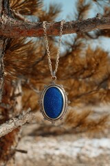Blue gemstone pendant in nature setting