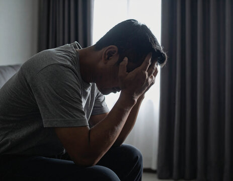  Depressed Person Sitting Alone in Darkness
