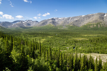 view from the height of the valley in the Khibiny mountain range in summer, mountains with snow in summer