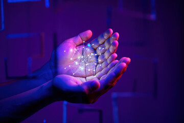 Hands holding a glowing network of interconnected dots against a purple and blue background