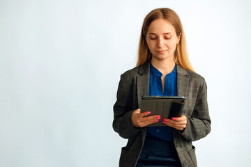 Portrait of serious determined Caucasian woman, wearing suit, student  holding digital tablet,...