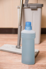 Bottle of Floor Cleaner with Mop and Bucket
