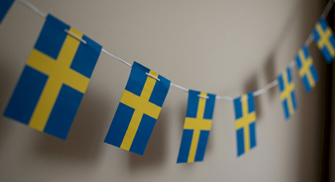 Swedish flags hanging in a festive display for celebration  