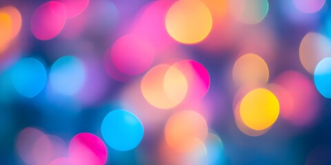 Fototapeta premium Abstract background of colorful bokeh lights in blue pink and yellow creating a festive mood