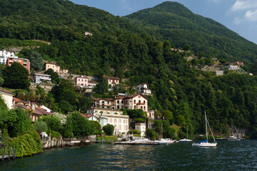 Villas on the shores of Lake Como, Italy - Summer landscape with hills and architecture.