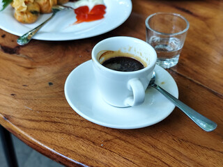 Serve various snacks and drinks on a warm wooden table, in an outdoor cafe. with natural blur.