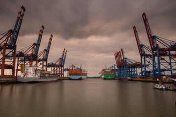 The gigantic container port in Hamburg during a beautiful sunset.