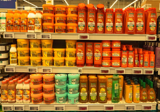 Colorful display of Garnier Fructis hair care products arranged neatly on supermarket shelves in Moscow, Russia, showcasing a variety of shampoos and conditioners for vibrant hair care solutions