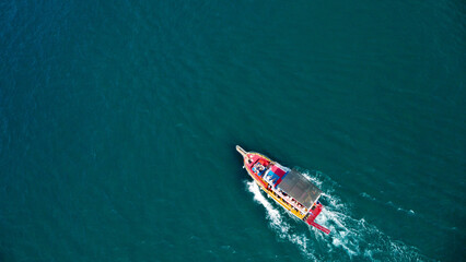 Aerial View of a Vibrant Tourist Boat on Deep Blue Sea
