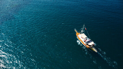 Fototapeta premium Aerial View of a Touristic Boat on Deep Blue Sea