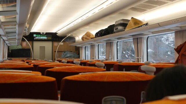 interior view inside express train cabin while running moving through snowy landscape area in northern japan. inside train japan public transportation
