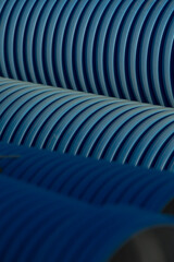 This is a detailed closeup view of a blue pipe, which features an interesting striped pattern on...