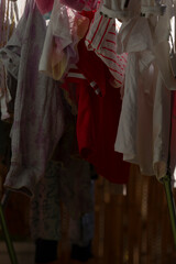 Fototapeta premium A variety of different clothes are currently hanging on a long clothes line in a stylish and organized manner, displaying their unique designs
