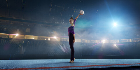 Rhythmic gymnastic girl on professional 3-d gymnastic stadium in night. 