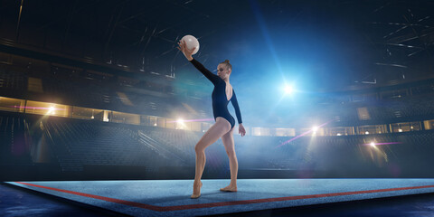 Rhythmic gymnastic girl on professional 3-d gymnastic stadium in night. 