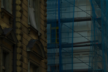 This is a tall building that features scaffolding prominently on its side, indicating ongoing...