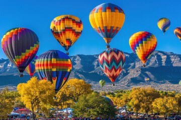 Obraz premium Colorful hot air balloons soar over the mountains during the autumn festival in a vibrant landscape