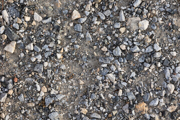 Texture rocky road. Path next to nature. Concept: Travels, roads, paths, trails, nature trails.