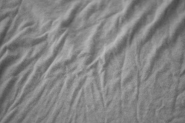 Texture of Dark grey crumpled textile cloth part with small folds