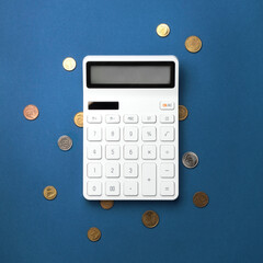  A calculator with a red upward arrow on a blue background, surrounded by scattered coins,...