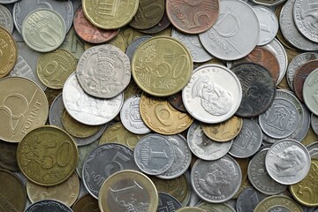 Big pile of different coins from various currencies and different countries around the world. Currency exchange