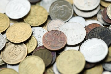 Big pile of different coins from various currencies and different countries around the world. Currency exchange