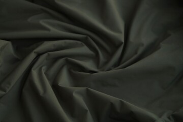 Fototapeta premium Texture of Dark green military uniform textile cloth with folds
