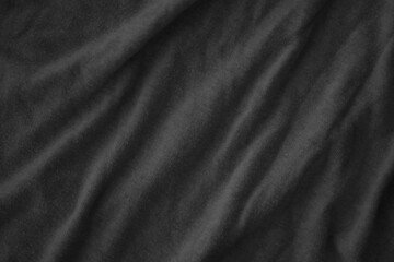 Texture of Dark grey crumpled textile cloth part with small folds