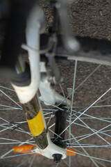 This is a close up view of a bicycle wheel that prominently features a distinct yellow stripe on...