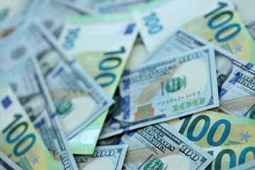 Big pile of Euro and USD banknotes. Many european and united states dollars